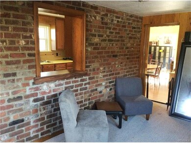 Den or office, with exposed brick, looking into th