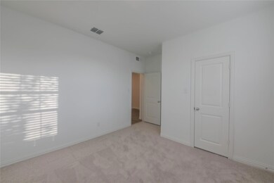 Unfurnished bedroom featuring light colored carpet
