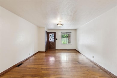 Entrance foyer featuring wood finished floors and baseboards