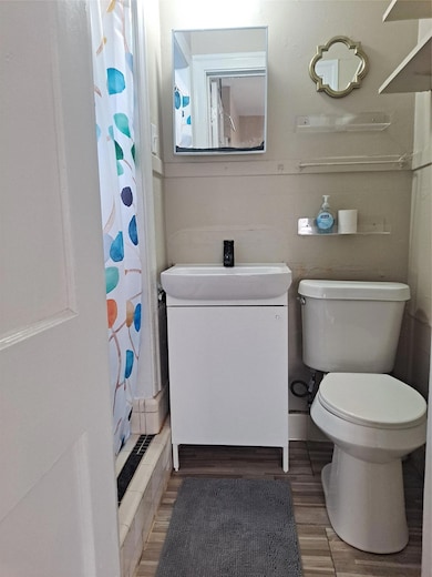 Bathroom with vanity, a shower with curtain, and 