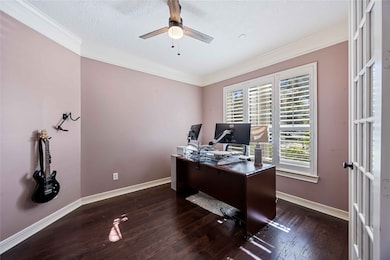 Bright and spacious home office with hardwood floors and large windows offering plenty of natural light.