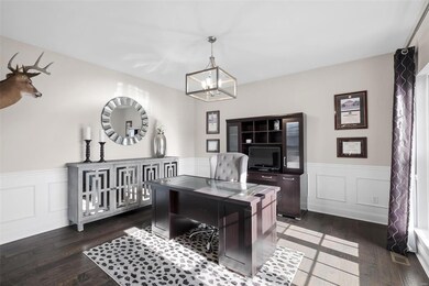 Office/formal family room with wainscoting.