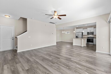 Unfurnished living room featuring ceiling fan and 
