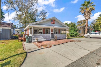 Bungalow featuring a front yard and central AC uni