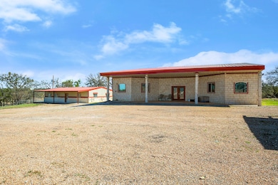 Back of property featuring french doors, metal ro