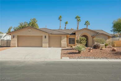 View of front facade with stucco siding, a garage,
