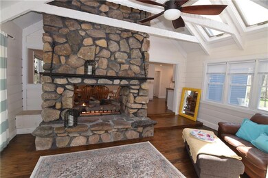 Two way stone fireplace just off kitchen, dining r