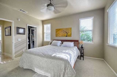 The master bedroom is bright and roomy, and featur