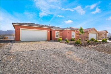 Single story home with decorative driveway, a tile