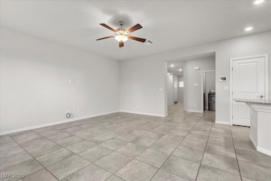 Spare room featuring recessed lighting, light tile patterned flooring, and a ceiling fan