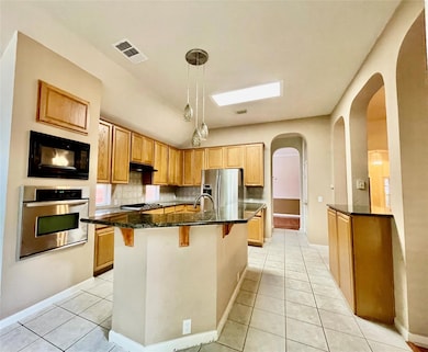 Kitchen with stainless steel appliances, arched w