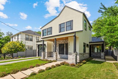 View of front of house with stone siding, stucco 