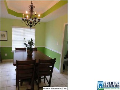 Dining room with tray ceiling provides plenty of s