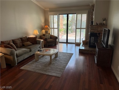 Living area featuring baseboards, dark wood-style