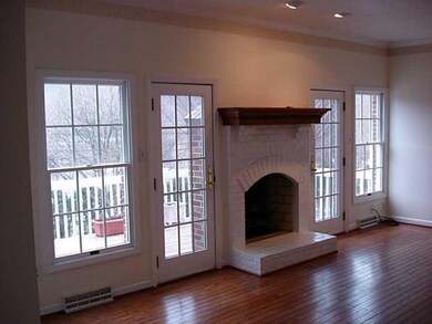 Living Room. The brick fireplace is flanked by a w