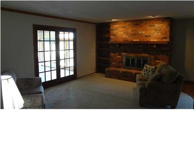 LIVING ROOM HAS DOUBLE DOOR ACCESS TO SUN ROOM