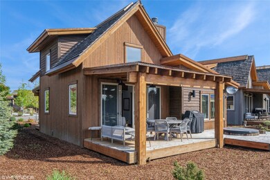 Back of property with a chimney and a wooden deck