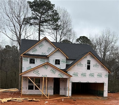 Property in mid-construction with covered porch an