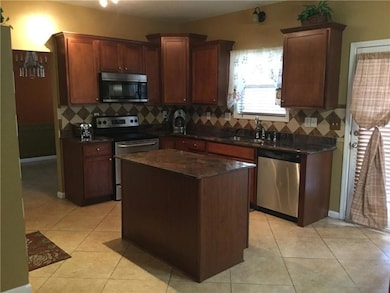 Kitchen featuring tasteful backsplash, a sink, sta
