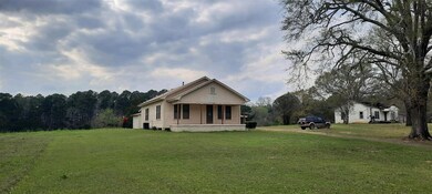 Back of property featuring a lawn