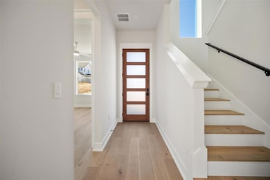 Foyer with visible vents, plenty of natural light