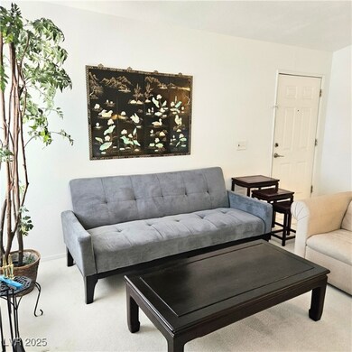 Living room featuring carpet floors and baseboards