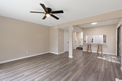 Unfurnished living room with stairs, wood finishe