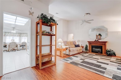 Living room featuring a ceiling fan, wood finished