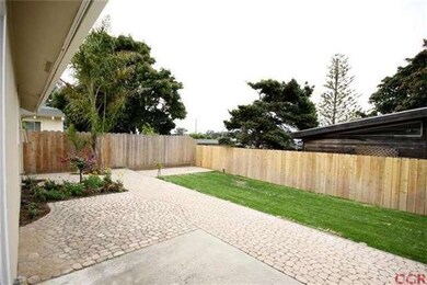 Inviting large backyard with new rear fence and la