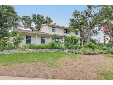 View of front facade with a front yard and brick siding