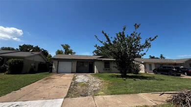 Ranch-style house with a garage and a front lawn