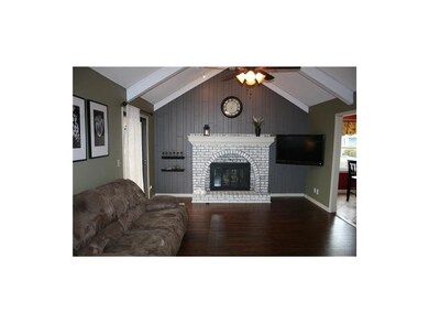 Great room offers a vaulted ceiling, an inviting  