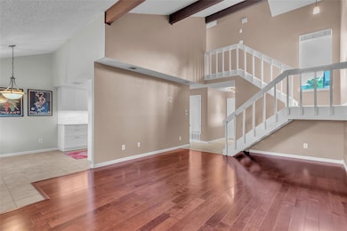 Unfurnished living room with high vaulted ceiling