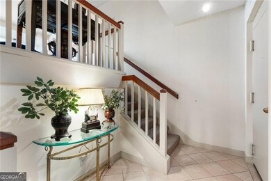 Stairway featuring tile patterned floors and baseb