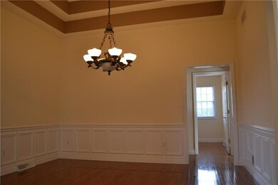 13x12 dining room with hardwood flooring, wainscot