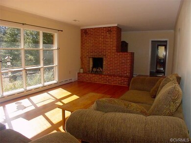 Living room with wood burning fireplace and crown 