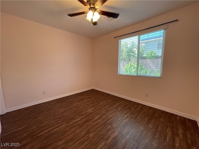 Spare room with dark wood finished floors, baseboa