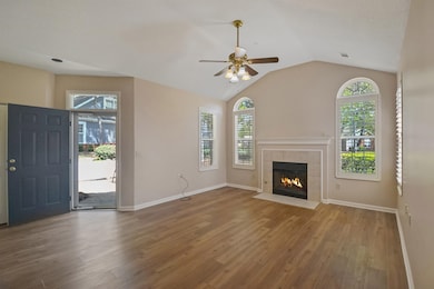 Great Room with fireplace.  Plantation Shutters on all windows and LPV flooring and freshly painted walls and baseboards.