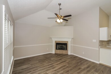 Unfurnished living room featuring vaulted ceiling,