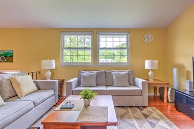 Living area with plenty of natural light and wood finished floors