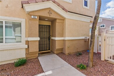 Doorway to property with fence, a gate, and stucco