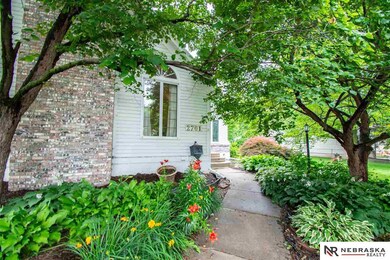 As you step off the sidewalk into the yard you are greeted by beds that have brilliant blooms through the spring and summer.