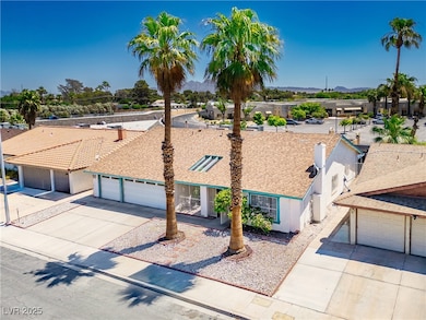 View of front of house featuring driveway, a garage, and stucco siding