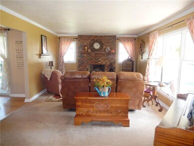The brick fireplace is the focal point of the livi