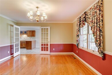 Entering the front door, the dining room is on your right. Hardwood floors gleam with natural light streaming through double window. Chair rail and crown moulding add special touch. French doors lead to kitchen and breakfast room, making entertaining easy.
