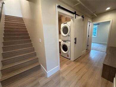 Washroom with stacked washer and clothes dryer, ca