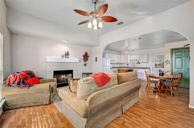 Living room with arched walkways, light wood-styl