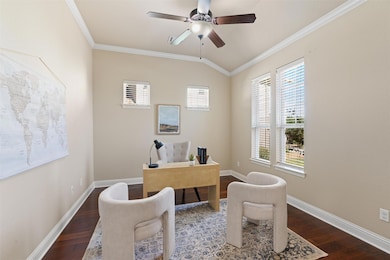 Office space featuring crown molding, dark wood-t