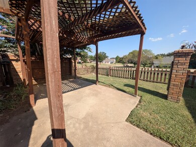 Fenced backyard featuring a patio and a pergola