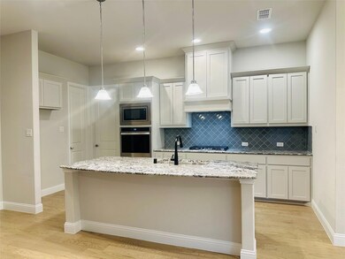 hardwood / wood-style floors, and a center island 
